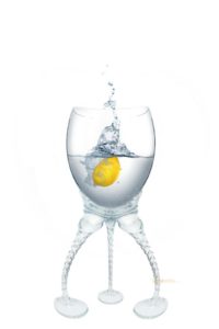 Healthier drinking habits. Drink water, sip wine. In picture a glass of water with lemon.