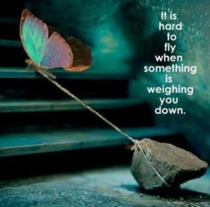 Defying Gravity in Life's darkest moments is taking control over what you can as illustrated by a butterfly weighed down by a stone.
