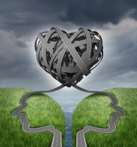 Working Away Relationships can hit a bump in the road, but forming a partnership will make it strong. Illustrated by roads forming a heart over two heads looking away from each other.
