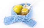Cold remedies that are all-natural work better than any OTC drugs against a common cold, illustrated by a scarf surrounding honey, garlic and lemon. Read more on thegoodista.com