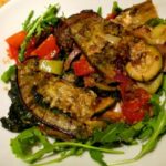 Aubergine Oven Bake in picture on a rocket salad bed
