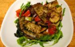 Aubergine Oven Bake in picture on a rocket salad bed