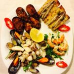 Italian feast antipasto illustrated by a plate of seafood.