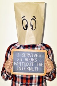 Digital detox survivor, illustrated by man with paperboy over his head holding a sign saying 'I survived 24 hours without internet'. 
