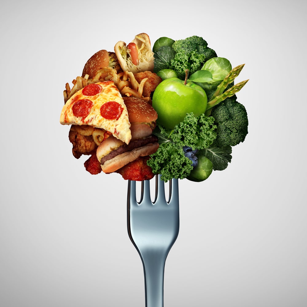 Permanent healthy lifestyle after diet illustrated by fork with junk and health food.